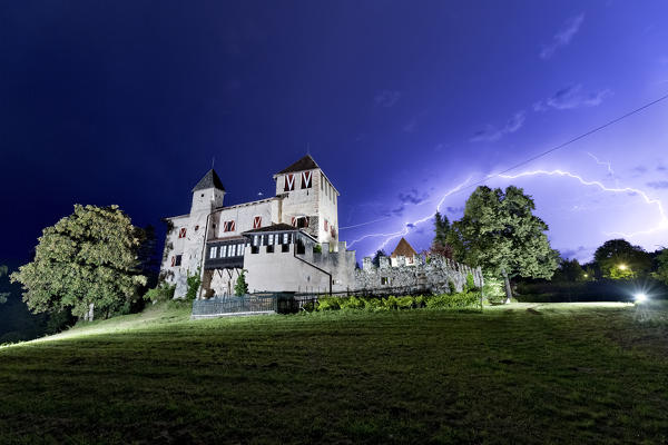 The medieval castle of Malgolo on a stormy night. Romeno, Non valley, Trento province, Trentino Alto-Adige, Italy, Europe.