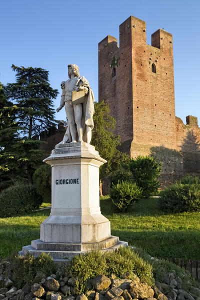 The statue of the painter Giorgione at the medieval walls of Castelfranco Veneto. Treviso province, Veneto, Italy, Europe.