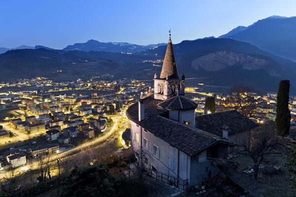 The church of Montalbano and the town of Mori. In the background the Brentonico plateau and the Mount Baldo. Vallagarina, Trento province, Trentino Alto-Adige, Italy, Europe.