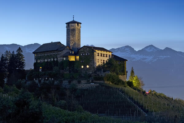 Evening falls on Castel Valer and the apple orchards of the Non valley. Tassullo, Trento province, Trentino Alto-Adige, Italy, Europe.