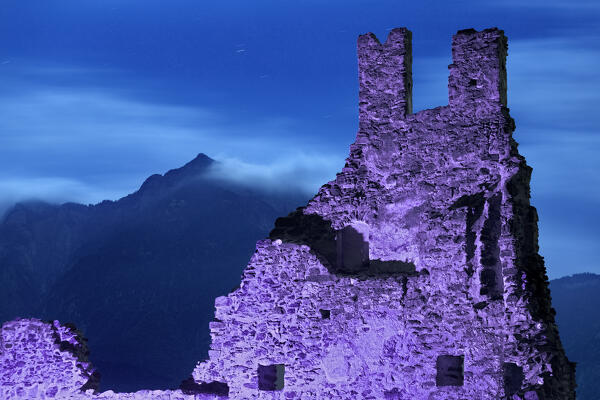 Selva Castle on a spooky night. In the background Mount Cima Vezzena. Levico Terme, Trento province, Trentino Alto-Adige, Italy, Europe.