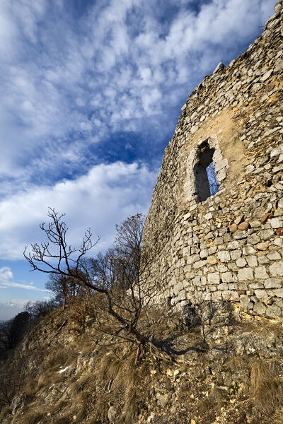 A door opens into the wall of the ancient medieval site of Saiori Castle. Brentonico, Trento province, Trentino Alto-Adige, Italy, Europe.