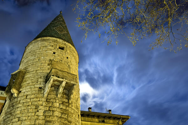 Full moon night at the medieval Torre Verde (Green Tower) in Trento: frightening legends are hidden inside. Trentino Alto-Adige, Italy, Europe.