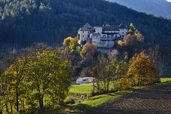 The medieval Badia Castle (Sonnenburg) and its rural area in autumn. San Lorenzo di Sebato / St. Lorenzen, Pusteria Valley, Bolzano province, Trentino Alto-Adige, Italy, Europe. 