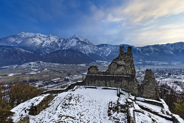 The crenellated ruins of Selva Castle and the Valsugana plain. In the background Cima Vezzena. Levico Terme, Trento province, Trentino Alto-Adige, Italy, Europe.