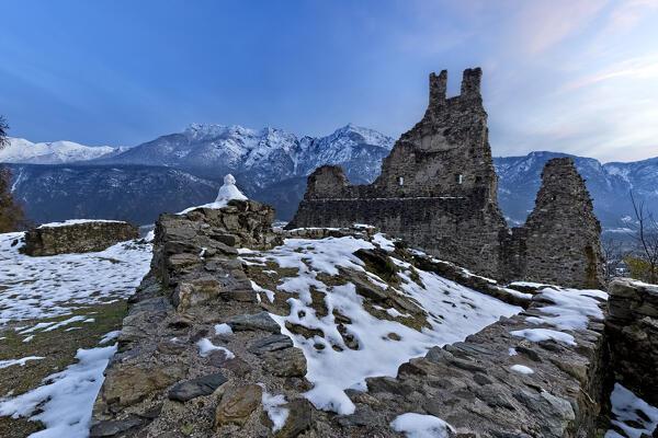 The medieval ruins of Selva Castle and mount Cima Vezzena in winter. Levico Terme, Trento province, Trentino Alto-Adige, Italy, Europe.