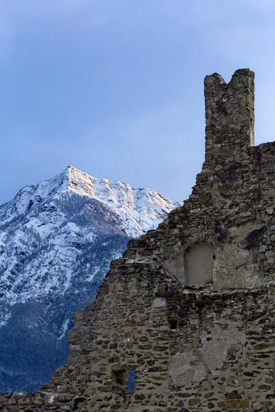 The crenellated ruins of Selva Castle and mount Cima Vezzena in winter. Levico Terme, Trento province, Trentino Alto-Adige, Italy, Europe.