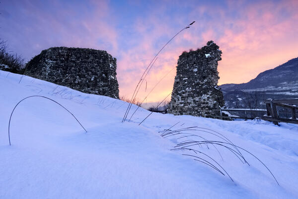 Winter sunset over the medieval ruins of Pradaglia Castle. Isera, Trento province, Trentino Alto-Adige, Italy, Europe.