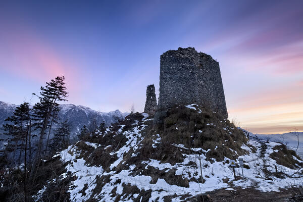 Sunset on the medieval ruins of San Pietro castle in Torcegno. Valsugana, Trento province, Trentino Alto-Adige, Italy, Europe.