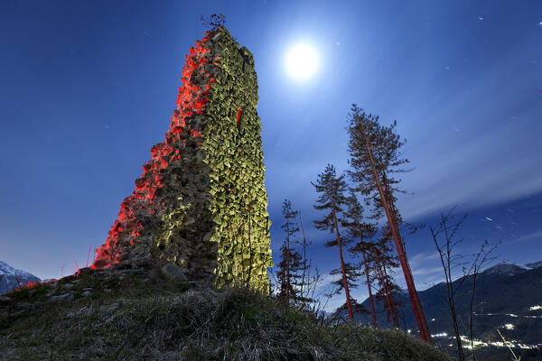 Ghostly night at the medieval ruins of San Pietro castle in Torcegno. Valsugana, Trento province, Trentino Alto-Adige, Italy, Europe.