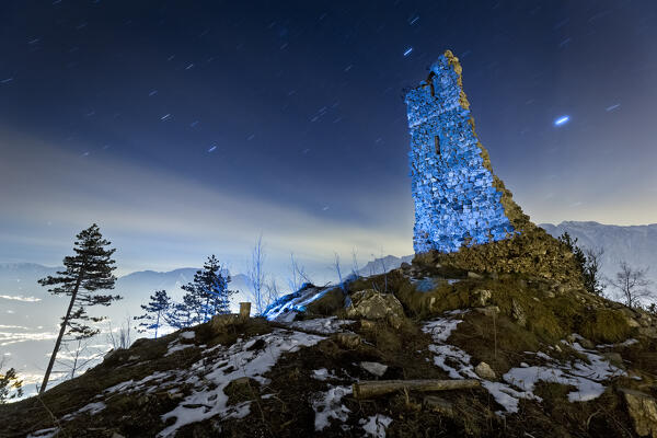 Spooky night at the medieval ruins of San Pietro castle in Torcegno. Valsugana, Trento province, Trentino Alto-Adige, Italy, Europe.