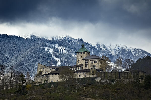 The imposing medieval structure of Ivano castle stands out among the Valsugana mountains. Castel Ivano, Trento province, Trentino Alto-Adige, Italy, Europe.