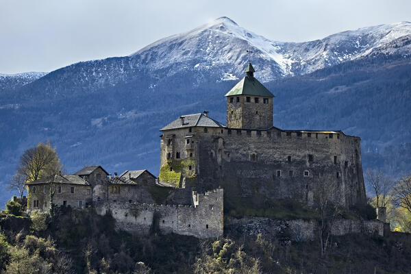 The imposing fortified structure of Ivano castle stands out among the Valsugana mountains. Castel Ivano, Trento province, Trentino Alto-Adige, Italy, Europe.