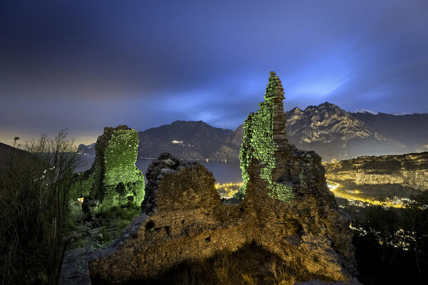 Mysterious night at the medieval ruins of Penede castle. Nago Torbole, Trentino, Italy.