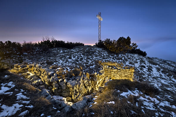 Mount Maggio by night: the trenches of the Great War and the large cross on the summit. Folgaria, Alpe Cimbra, Trentino, Italy.