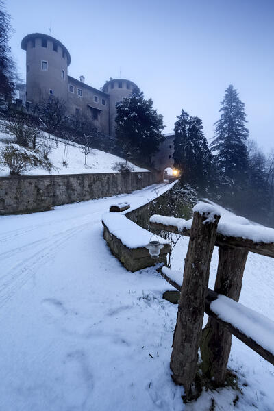 The medieval castle of Campo in snowy winter. Campo Lomaso, Giudicarie, Trentino, Italy.