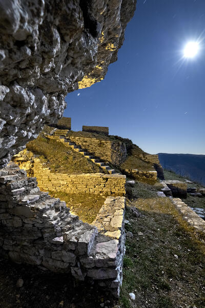 Vestiges of the Italian barracks of the Great War in Corno della Paura on a moonlit night. Brentonico, Trentino, Italy.