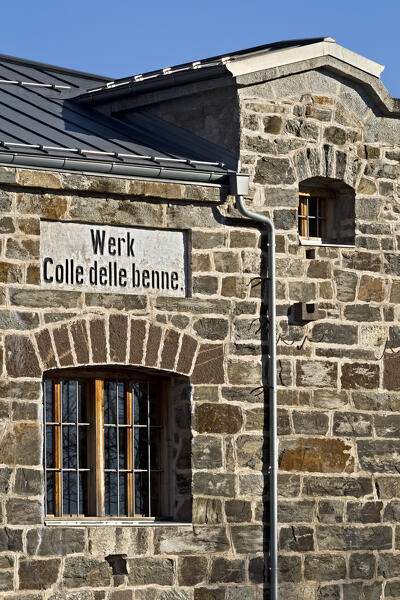 Fort Colle delle Benne: the facade of the Habsburg fortress with the entrance signboard. Levico Terme, Trentino, Italy.