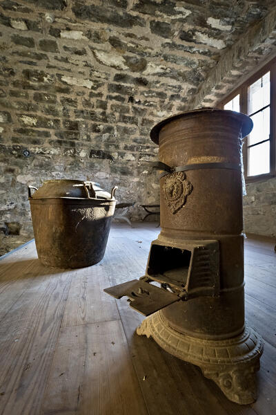 Fort Colle delle Benne: museum setup with a wood-burning stove from the Great War. Levico Terme, Trentino , Italy.