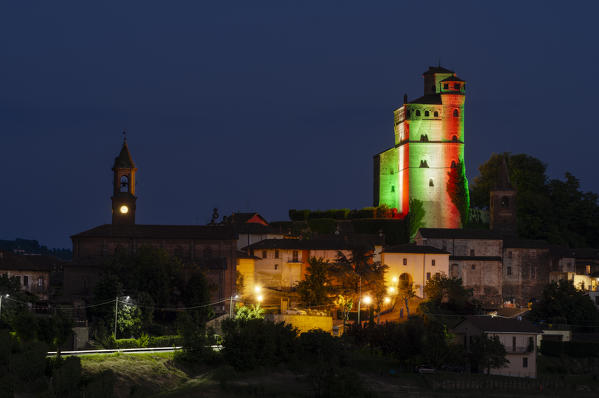 Serralunga d'Alba Castle coloured with the italian flag at dusk, Serralunga d'Alba, Piedmont, Italy