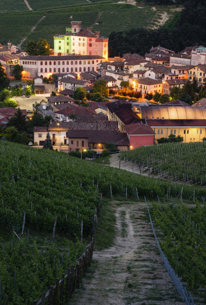 Barolo Castle through the vineyards coloured with the italian flag at dusk, Barolo, Piedmont, Italy