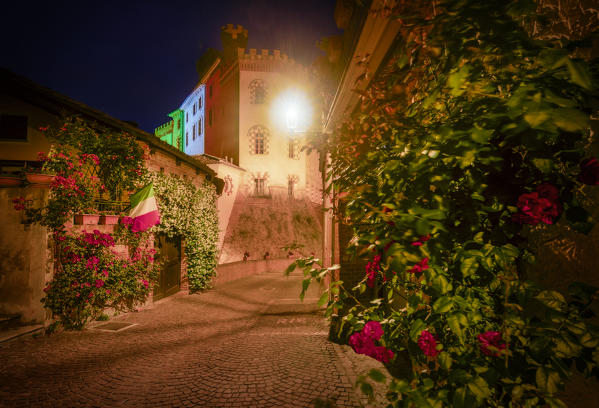 Barolo Castle coloured with the italian flag at dusk, Barolo, Piedmont, Italy