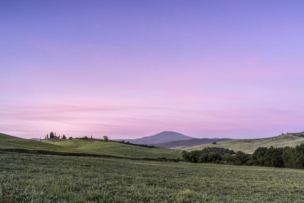 Europe, Italy, Tuscany, Val d'Orcia: the change of colours between night and day above the sleeping hills near Poggio Covili