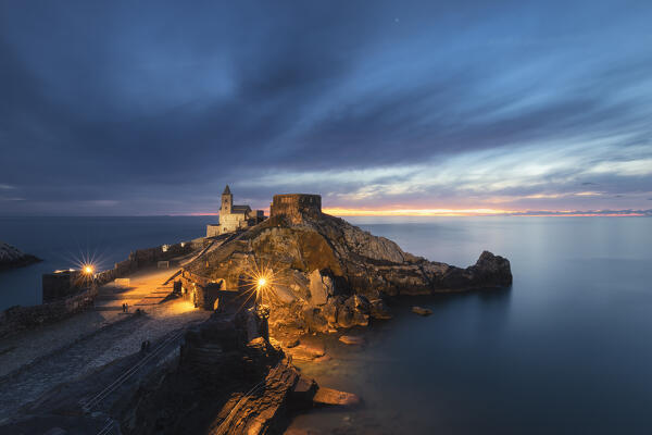 The last lights of the sunset on the horizon that remain almost suspended in an evening in front of Portovenere, La Spezia province, Liguria, Italy, Europe