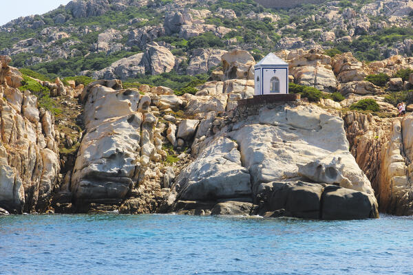 View from the boat on the Cappella della Madonnetta in Cala Carlotto, La Maddalena island, Sassari province, Sardinia, Italy, Europe.

