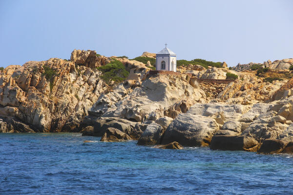 View from the boat on the Cappella della Madonnetta in Cala Carlotto, La Maddalena island, Sassari province, Sardinia, Italy, Europe.
