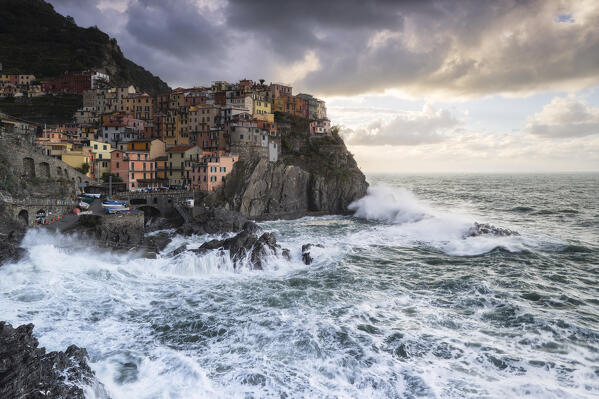 Storm at sunrise on the cliff of the village of Manarola, Cinque Terre National Park, municipality of Riomaggiore, La Spezia province, Liguria district, Italy, Europe
