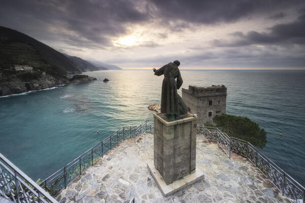 The morning sun illuminates the statue of San Francesco d'Assisi, Cinque Terre National Park, municipality of Monterosso al Mare, La Spezia province, Liguria district, Italy, Europe
