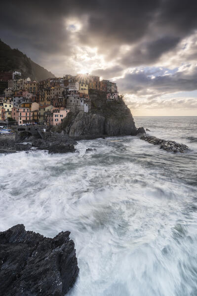 The star of the sun in the morning on Manarola, Cinque Terre National Park, municipality of Riomaggiore, La Spezia province, Liguria district, Italy, Europe
