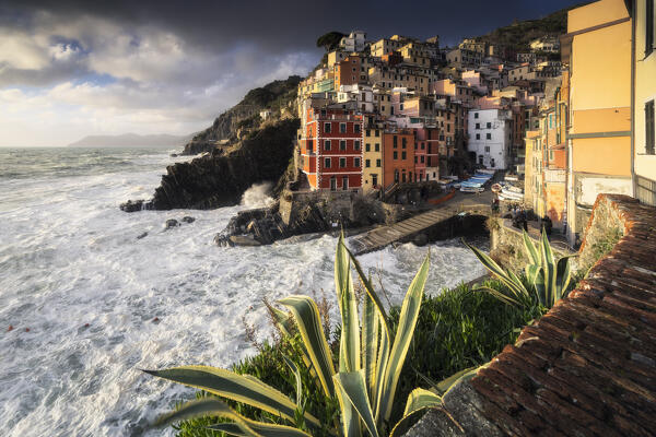 Storm surge at sunset on the village of Riomaggiore, National Park of Cinque Terre, municipality of Riomaggiore, La Spezia province, Liguria district, Italy, Europe
