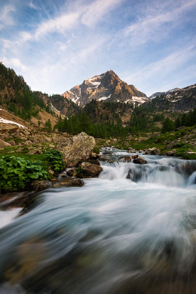 The Malinvern peack and Riofreddo River at sunset. Europe. Italy. Piedmont. Cuneo district. Stura Valley