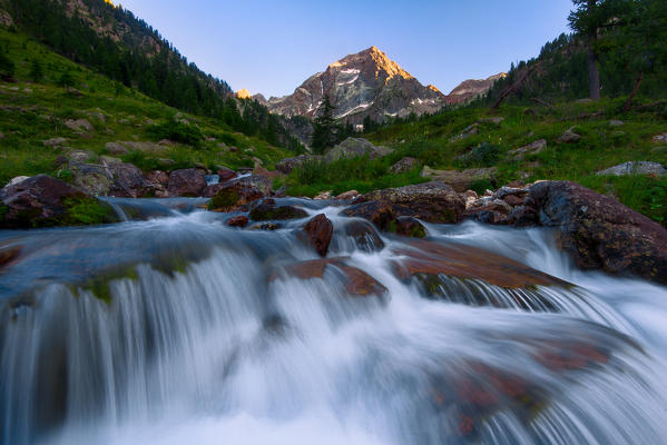 The Malinvern peack and Riofreddo River at sunset. Europe. Italy. Piedmont. Cuneo district. Stura Valley