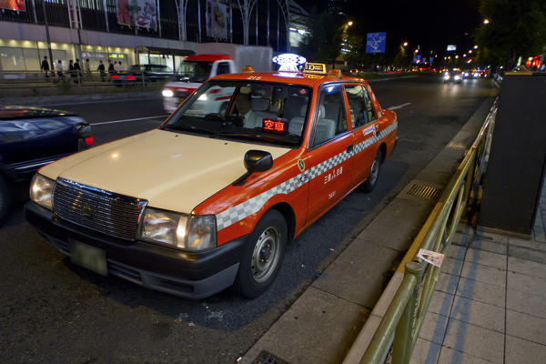 A taxi with the right guidance in the night of the Japanese metropolis. Tokyo, Japan