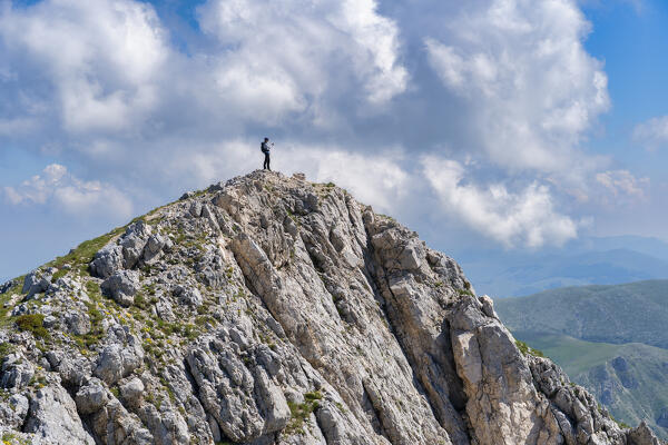 Italy, Lazio, Apennines mountain range, Hiker on top of Terminillo in Summer