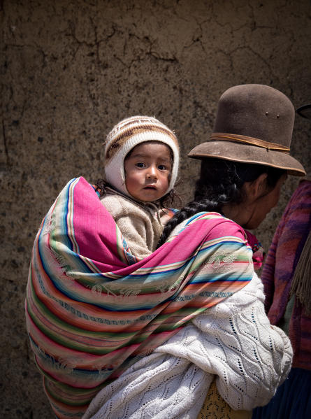 Aymara child and his mother dressed with the typical costume. Aymaras are the native population of the Titicaca Lake area, in Bolivia, South America.