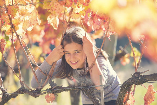 Europe,Italy,Umbria,Perugia district,Montefalco.
Child playing in a vineyard.