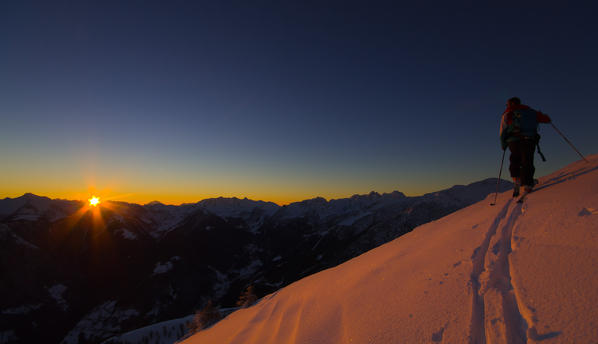 Skier at sunrise, Cima della Rosetta, Valgerola, Lombardy, Italy