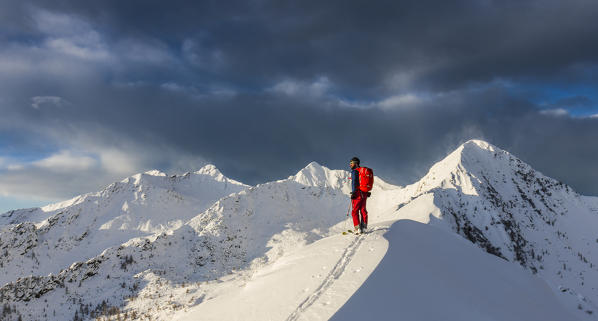 Skier on the top of Cima della Rosetta with strong wind, Valgerola, Valtellina, Lombardy, Italy, Alps