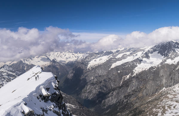 Skiers over Val di Mello, Valtellina, Lombardy, Italy, Alps