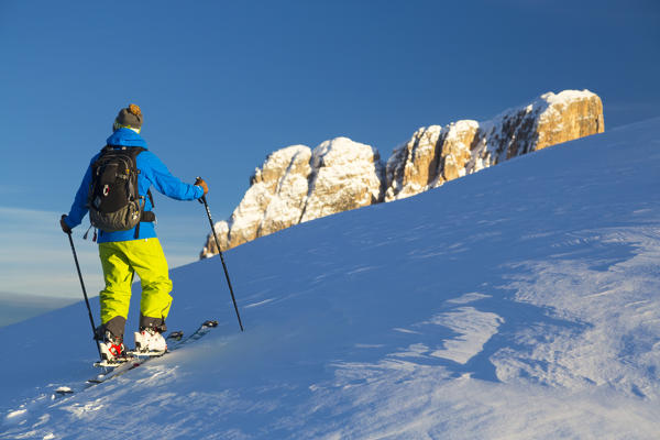 Ski touring on Croda Negra, on the background Averau peak. Passo Falzarego, Veneto, Italy.