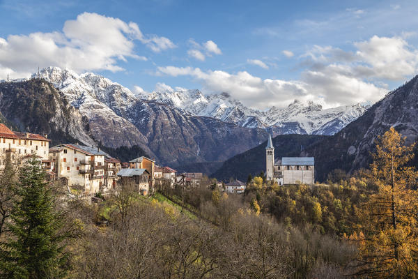 Ancient church and village of  Valle di Cadore with snowcapped Dolomiti di Oltrepiave on the background, Belluno, Veneto, Italy, Europe