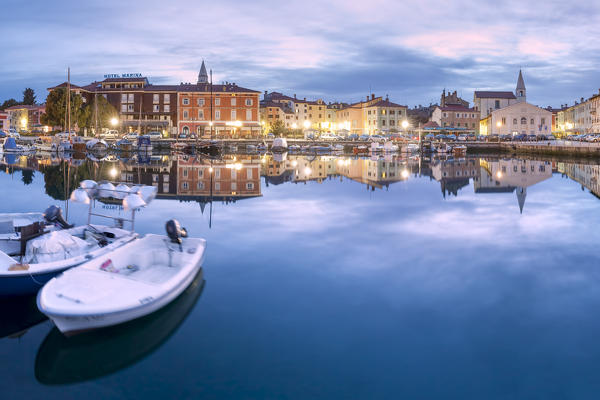 Europe, Slovenia, Primorska, Izola. Old town and the harbour with fishing boats at dusk