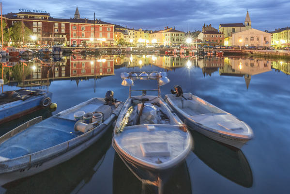 Europe, Slovenia, Primorska, Izola. Old town and the harbour with fishing boats at dusk