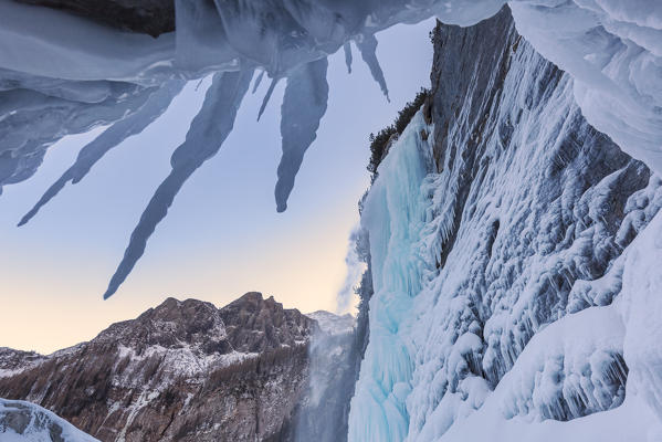 The Gares waterfall framed by icicles,  Canale d' Agordo, Agordino, Belluno, Veneto, Italy