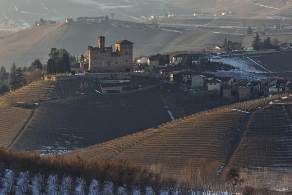 Langhe, Cuneo district, Piedmont, Italy. Langhe wine region winter snow,sunset over the Grinzane castle
