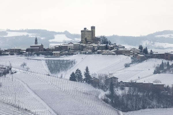 Langhe, Cuneo district, Piedmont, Italy. Langhe wine region winter snow, Serralunga d’Alba castle
